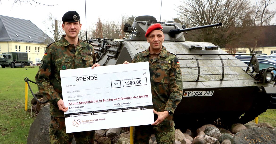 Bataillonskommandeur Oberstleutnant Dr. phil. Hendrik Hoffmann (li.) übergibt den symbolischen Spendenscheck an Oberstabsfeldwebel Ingo Evers. 